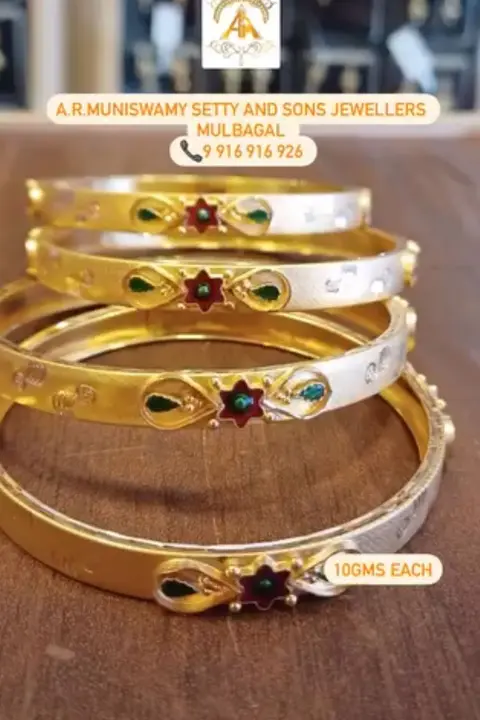 Gold and silver bangles with enamel stars, stacked together.